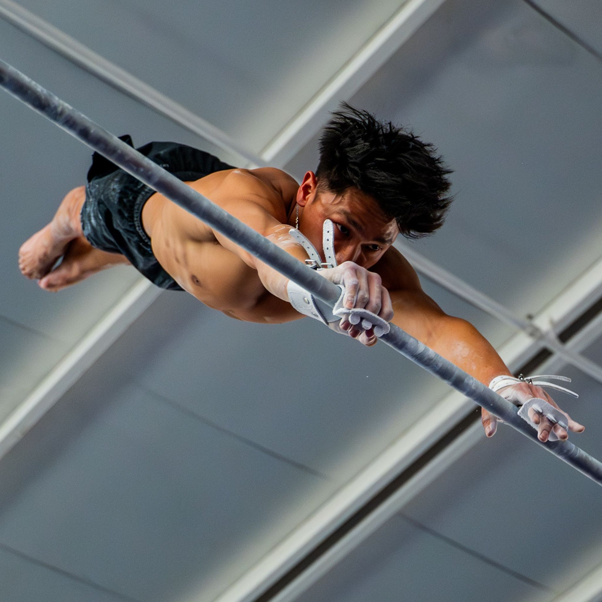 Olympic gymnast Yul Moldauer competing on high bar wearing his Wolf Wear signature grips