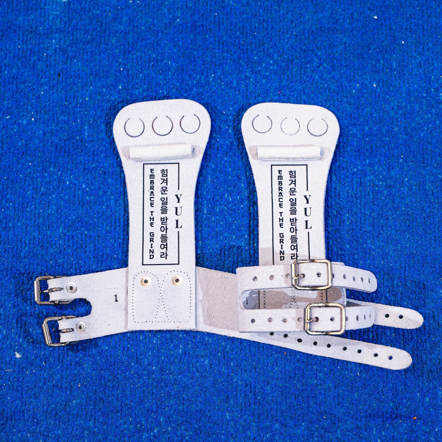 Yul Moldauer signature high bar gymnastics grip by Wolf Wear, showing YUL branding and Embrace the Grind detail