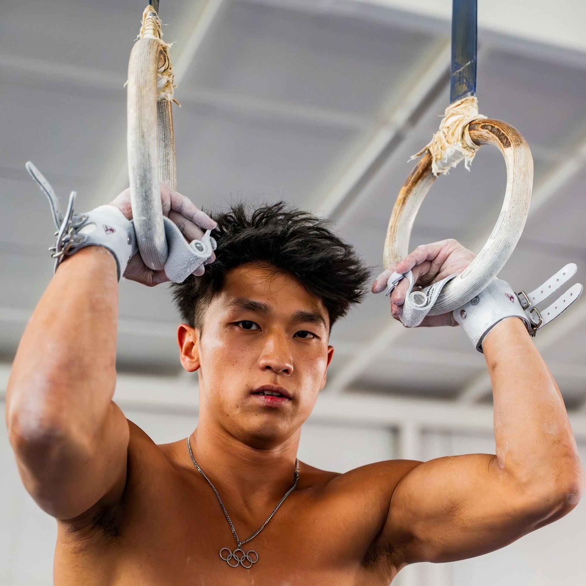 Olympic gymnast Yul Moldauer training on still rings wearing his Wolf Wear signature grips