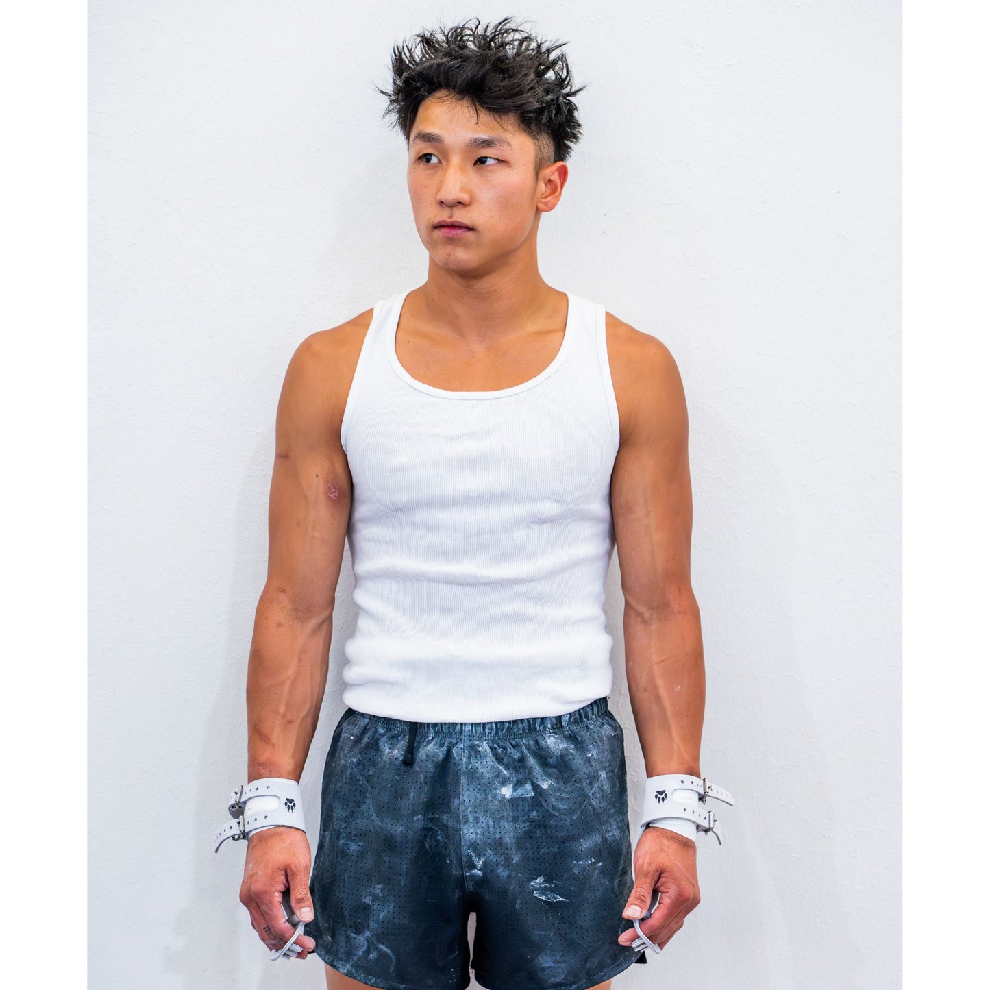 Yul Moldauer wearing Wolf Wear signature high bar grips on both wrists